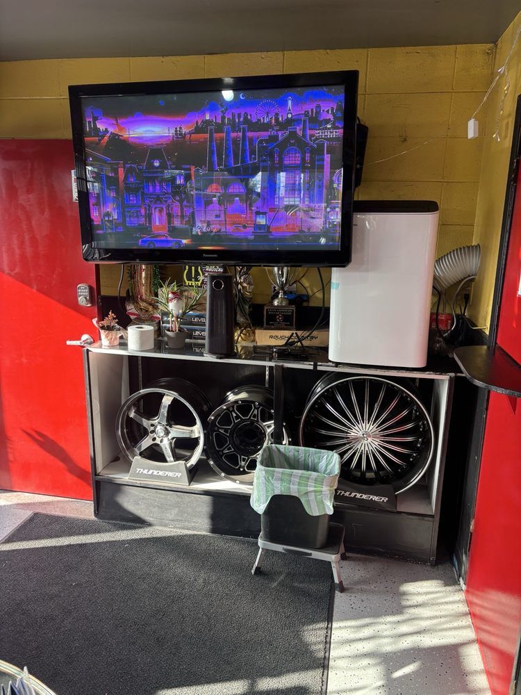 The customer waiting area, with a TV above a display of aftermarket rims